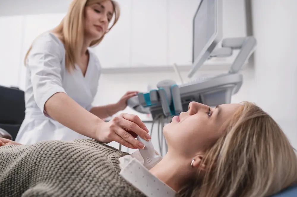 Woman getting her neck checked by doctor