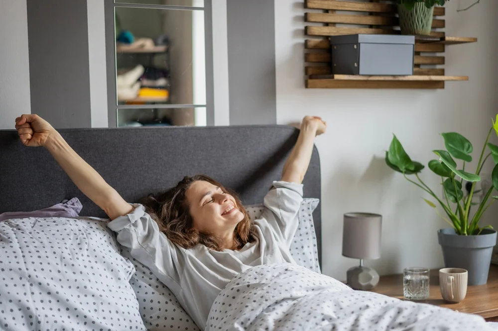 woman waking up happy in bed