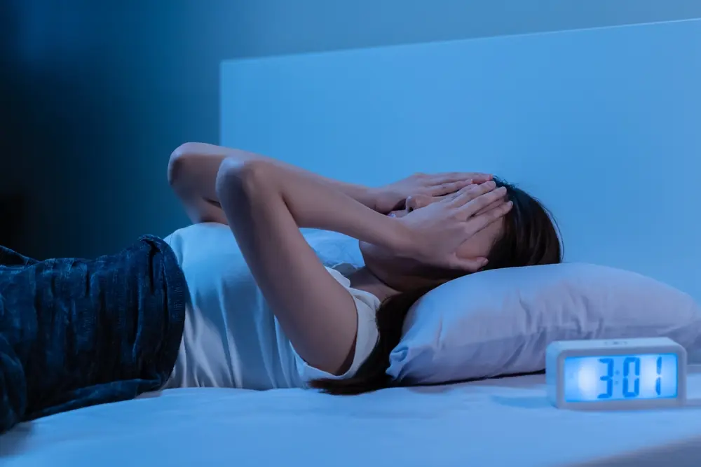 Woman lying in bed with insomnia