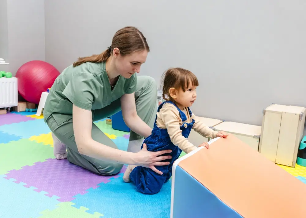 female therapist playing with child